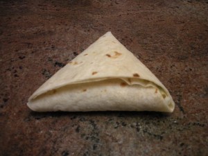 Tuck tortilla end into pocket.